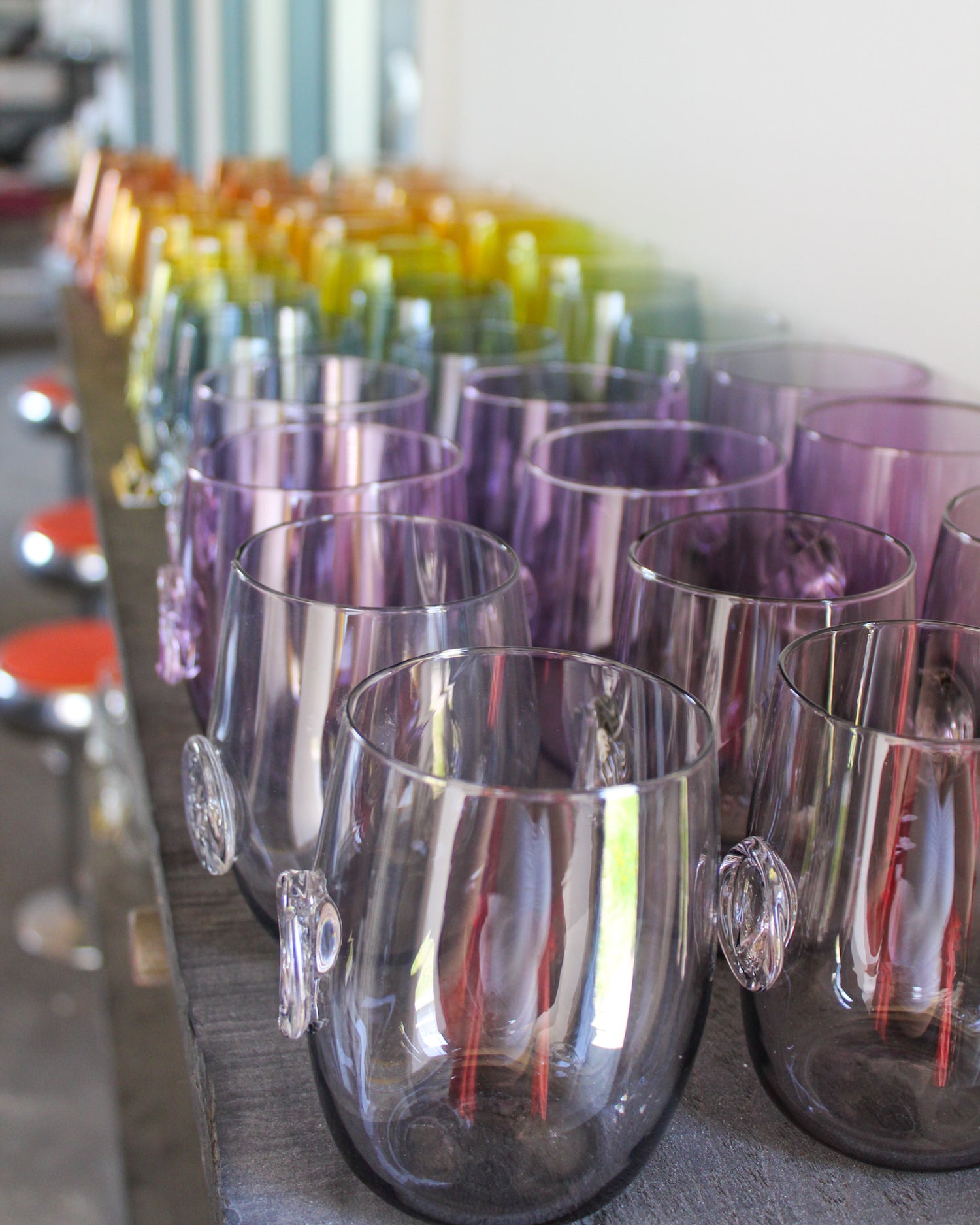 closeup of stemless wine glass rainbow in studio 