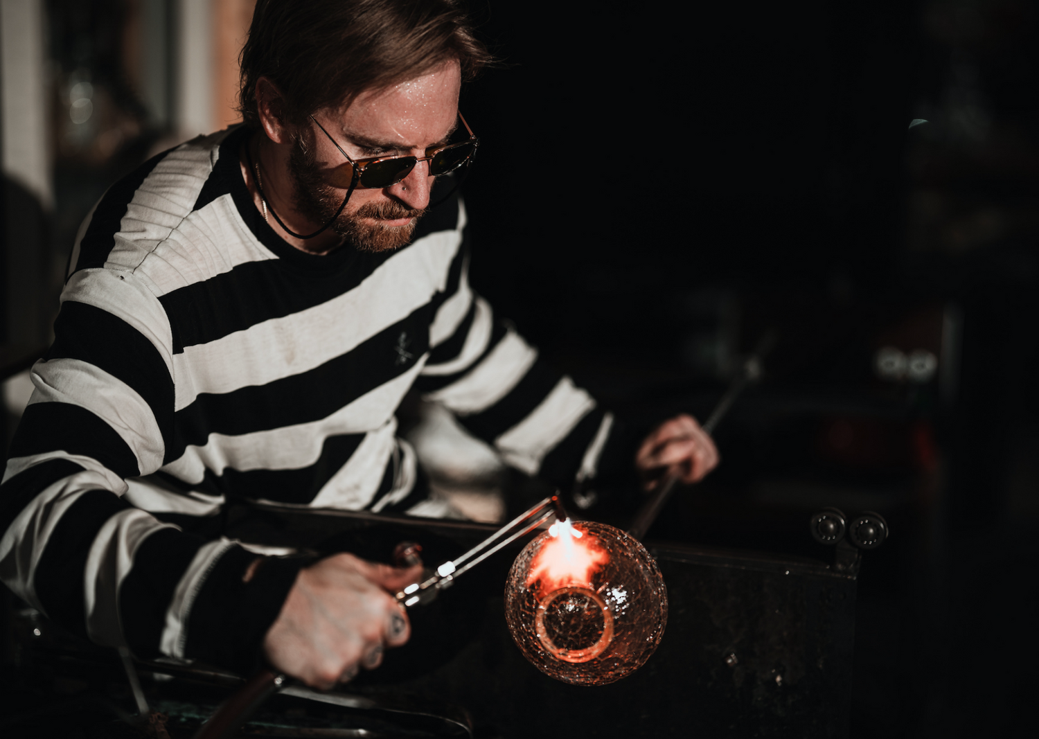 closeup of woody torching a glass orb